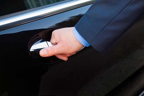 Hand opening limousine door on a business trip